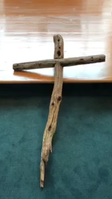 Drift wood cross laying
			on the floor