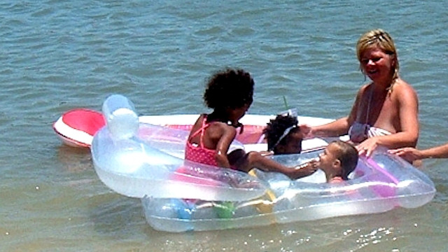 Children on raft at beach