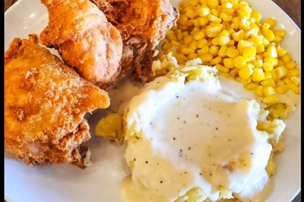 Plate of fried chicken, mash potatoes, and corn
